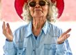 Elderly woman with red sun hat, looking slightly confused. Many people are similarly confused about Myrbetriq, a treatment option for overactive bladder.