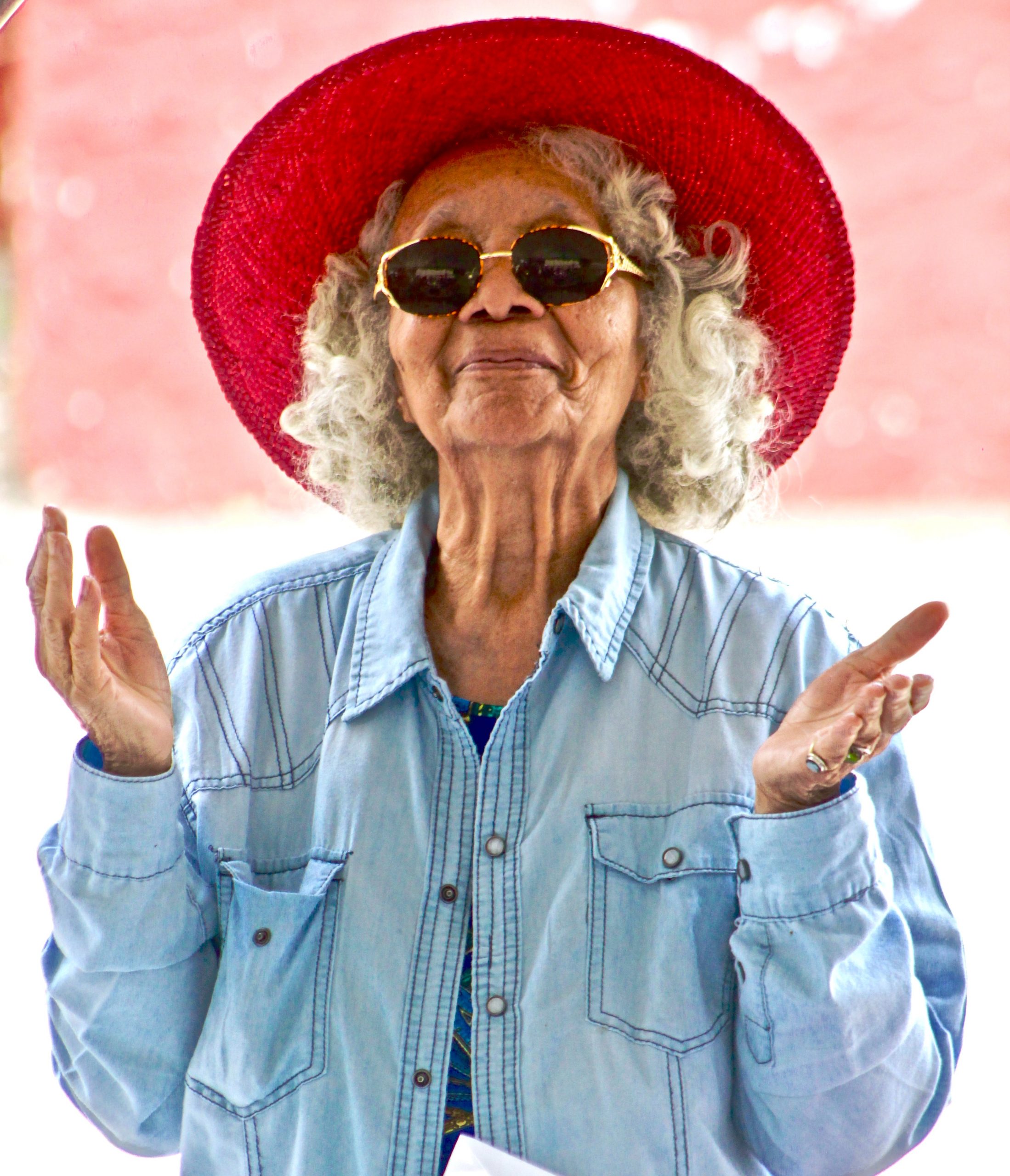 Elderly woman with red sun hat, looking slightly confused. Many people are similarly confused about Myrbetriq, a treatment option for overactive bladder.