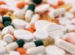 A variety of pills of different colours all together on a table, indicating that many prescription medications can be bought online, making getting your pills easier than every before.